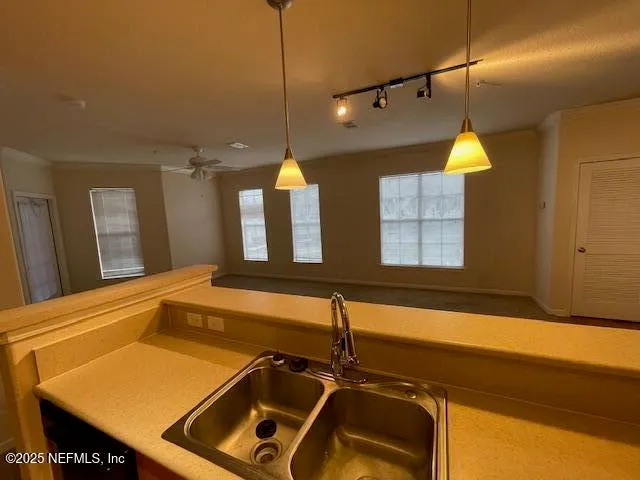 a room with pool table and windows