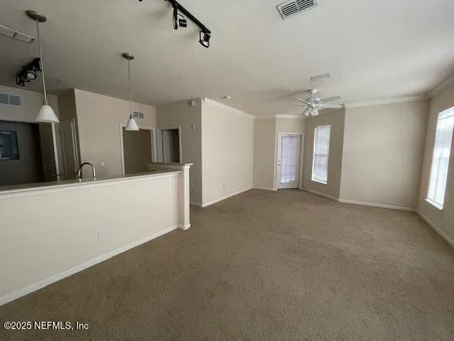 a view of a livingroom with furniture and chandelier fan