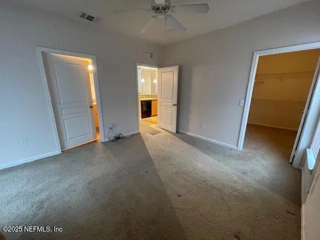 a view of a room with a ceiling fan