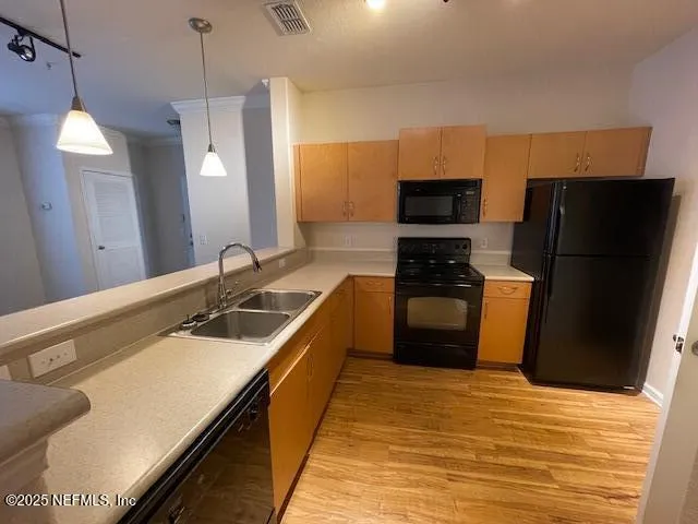 a kitchen with stainless steel appliances granite countertop a refrigerator a stove and a sink