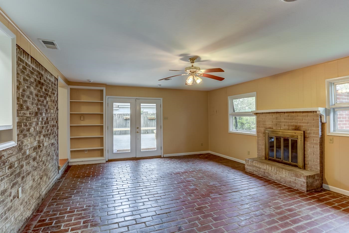 1542 Dearing Road Memphis, TN 38117 - Photo 5 of 25 a view of an empty room with a fireplace and a window
