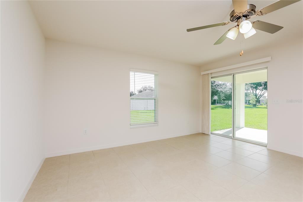 1668 Gopher Tree Street Mascotte, FL 34753 - Photo 2 of 16 an empty room with windows and fan