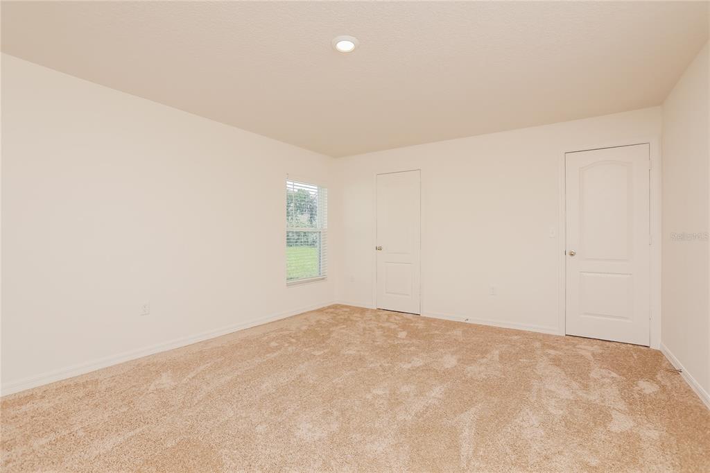 1668 Gopher Tree Street Mascotte, FL 34753 - Photo 7 of 16 an empty room with windows