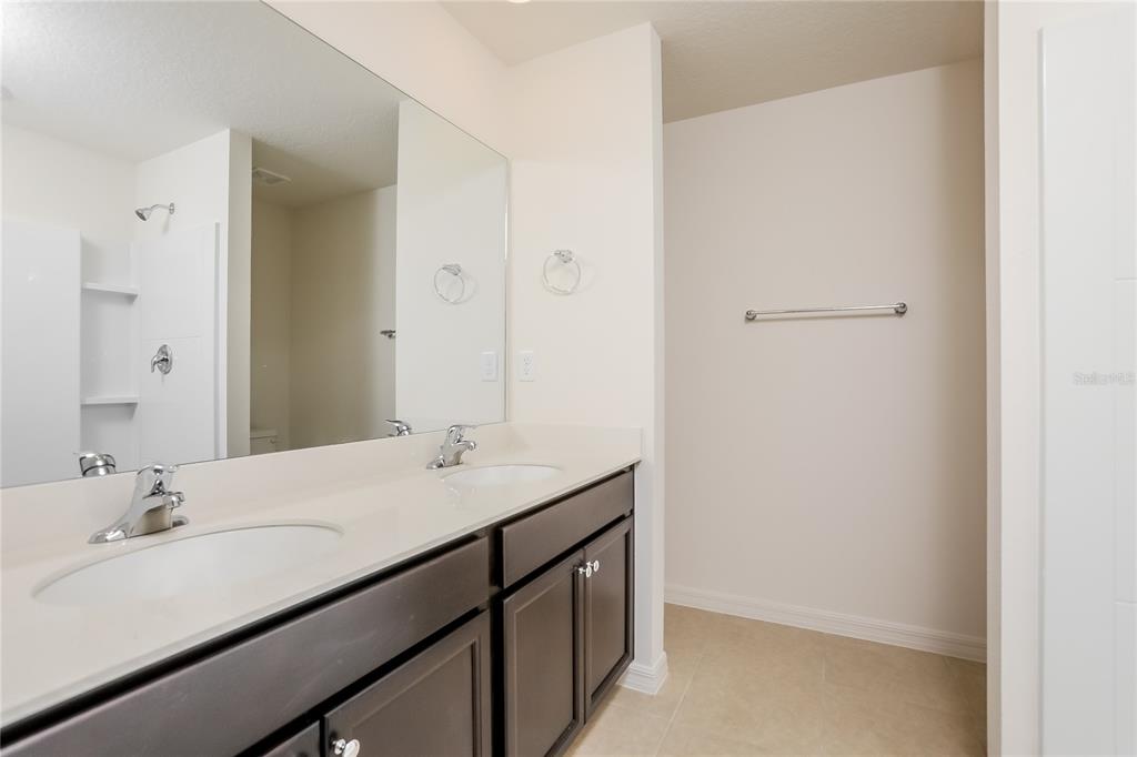 1668 Gopher Tree Street Mascotte, FL 34753 - Photo 8 of 16 a bathroom with a sink and a mirror