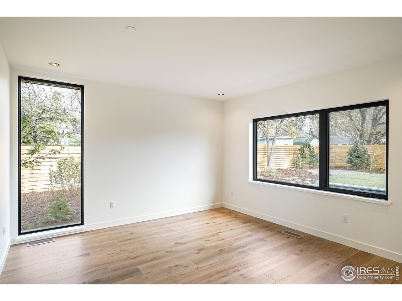2125 Upland Avenue Boulder, CO 80304 - Photo 15 of 36 a view of an empty room with wooden floor and a window