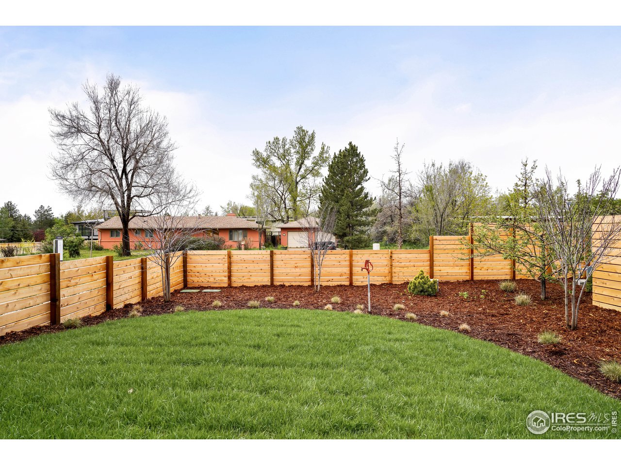 2125 Upland Avenue Boulder, CO 80304 - Photo 26 of 36 a view of a yard with a house in the background