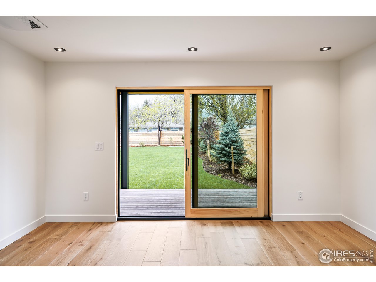 2125 Upland Avenue Boulder, CO 80304 - Photo 32 of 36 a view of an empty room with wooden floor and a window