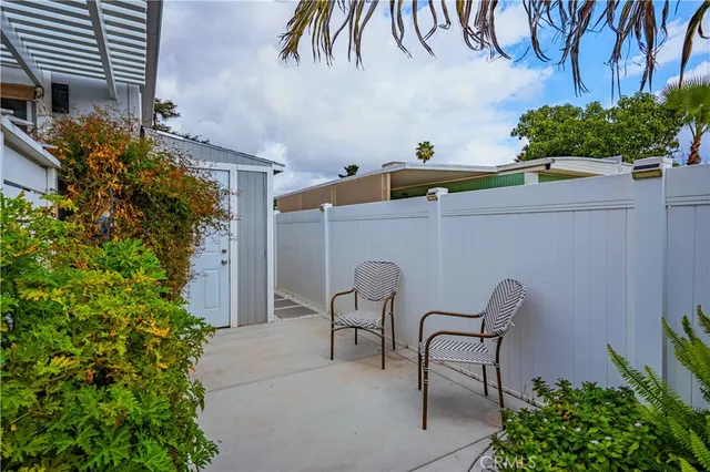 a view of patio with table and chairs and potted plants