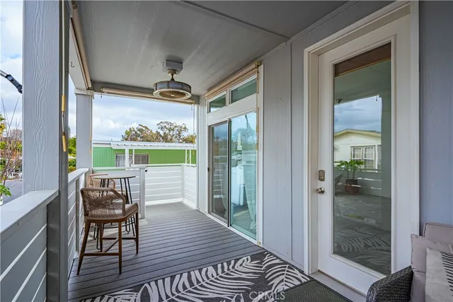 a view of a porch with furniture and a yard