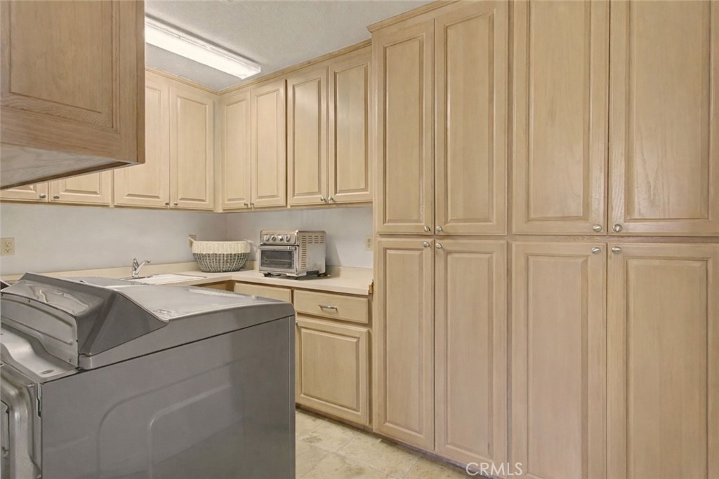 1605 Ridge Drive Merced, CA 95340 - Photo 16 of 63 Large laundry Rm. This photo doesn't do it justice. It has lots of storage, a sink, and a full wall of floor to ceiling cabinets with Pull out shelves