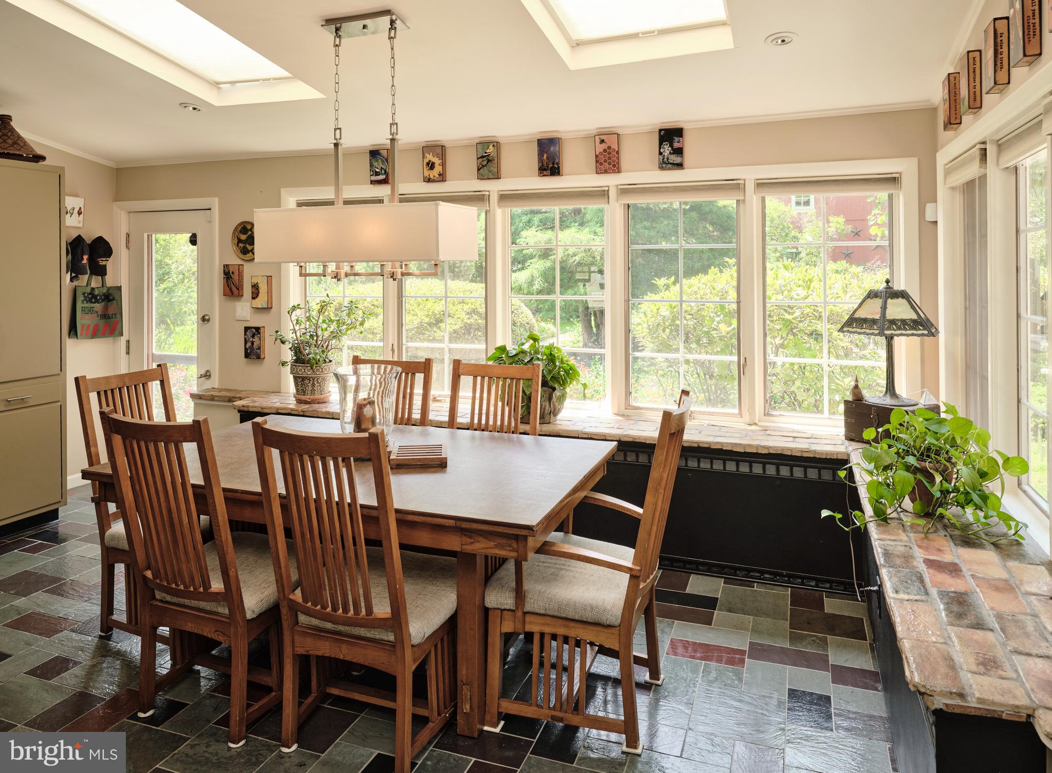 2125 Old Woods Road Green Lane, PA 18054 - Photo 14 of 53 a view of a dining room with furniture large windows and wooden floor