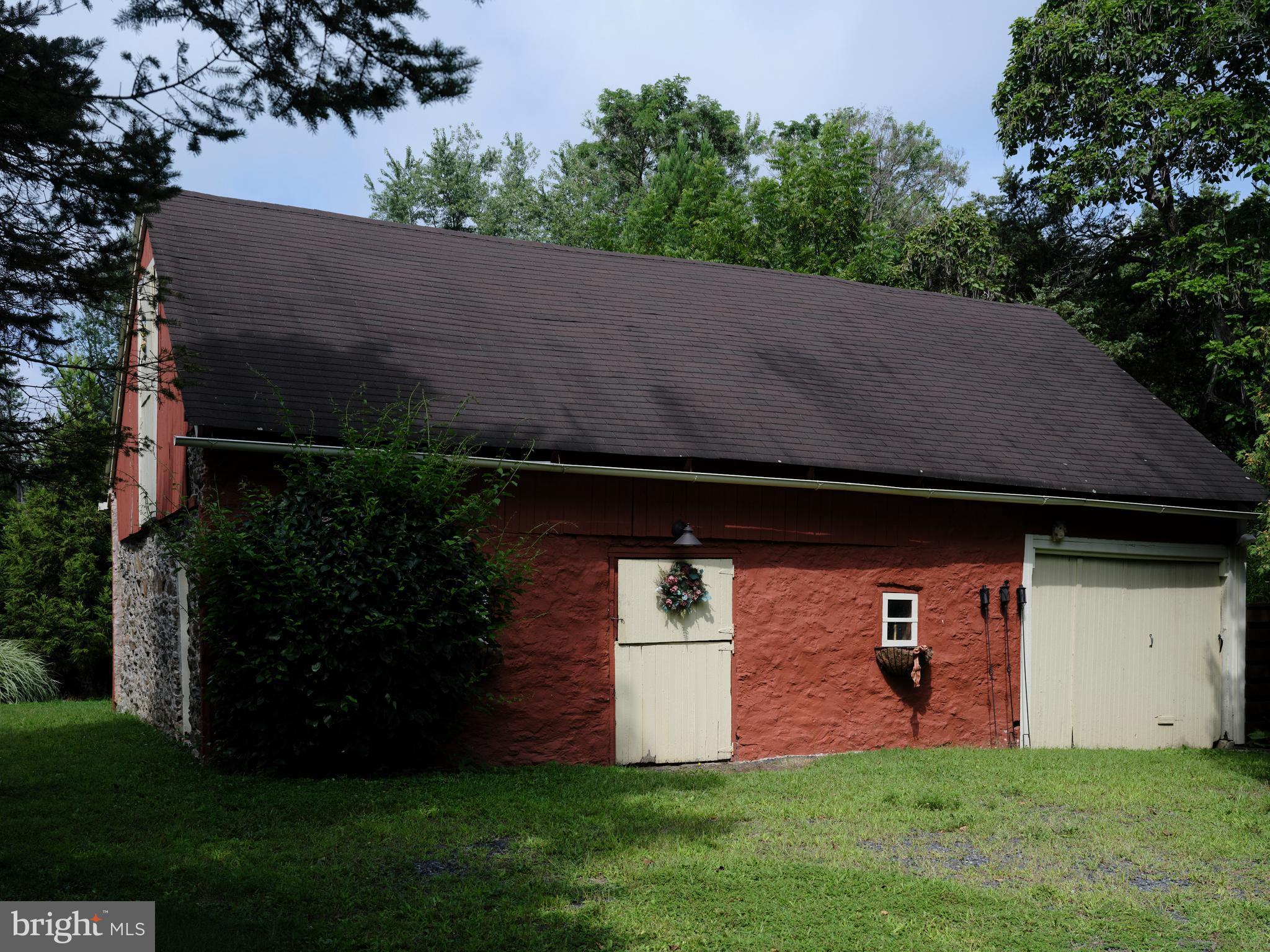 2125 Old Woods Road Green Lane, PA 18054 - Photo 50 of 53 a view of a backyard with potted plants and a large tree