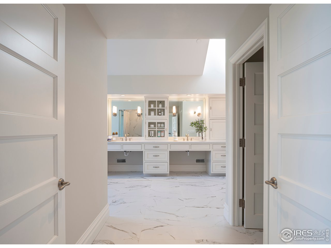 2205 Topaz Drive Boulder, CO 80304 - Photo 28 of 33 a large white bathroom with a large mirror vanity and shower