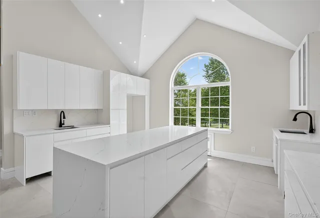 a view of bathroom with windows and dual sink