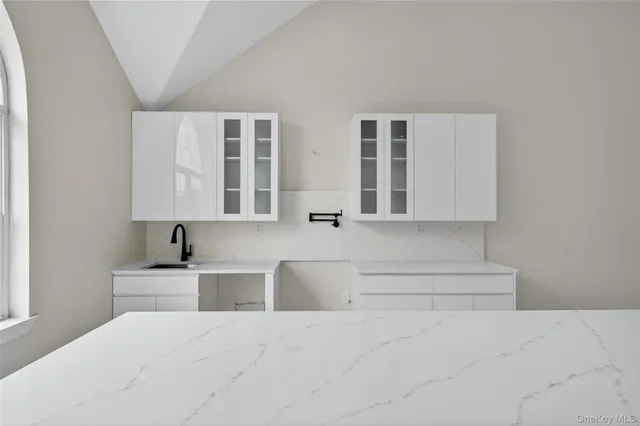 a living room with granite countertop furniture and lamp