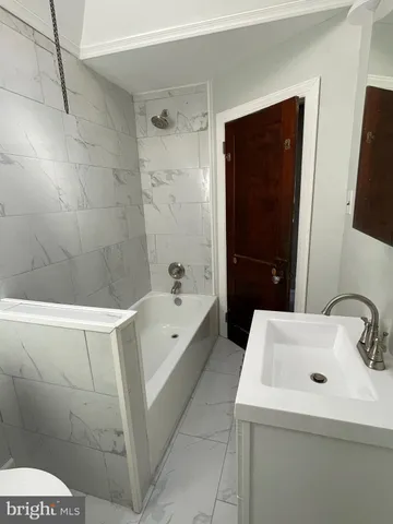 a bathroom with a sink a toilet and bathtub