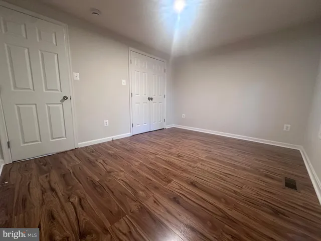 a view of room with wooden floor