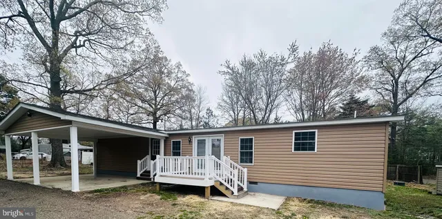 a view of a house with a yard and roof deck