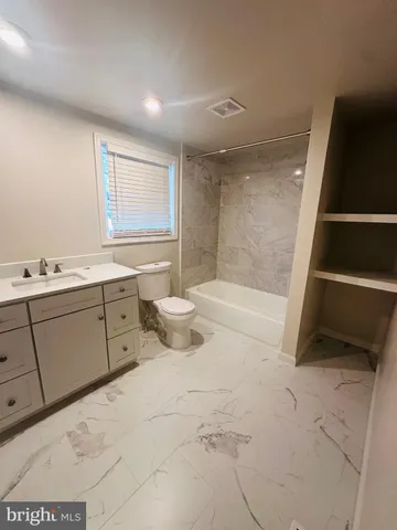 a bathroom with a bathtub sink and toilet