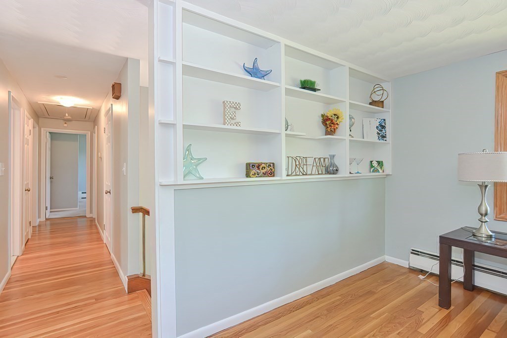 24 Cherry Road Framingham, MA 01701 - Photo 15 of 30 a view of a hallway with cabinet and wooden floor