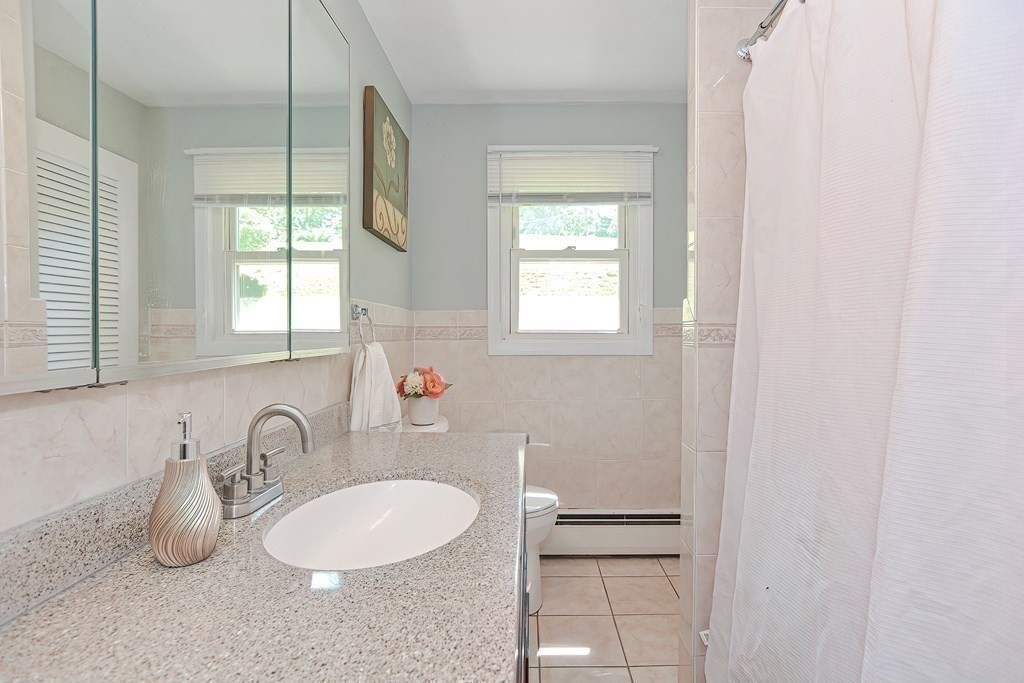 24 Cherry Road Framingham, MA 01701 - Photo 16 of 30 a bathroom with a sink and a mirror