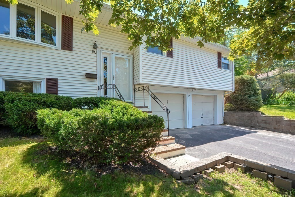 24 Cherry Road Framingham, MA 01701 - Photo 29 of 30 a front view of a house with a yard and garage