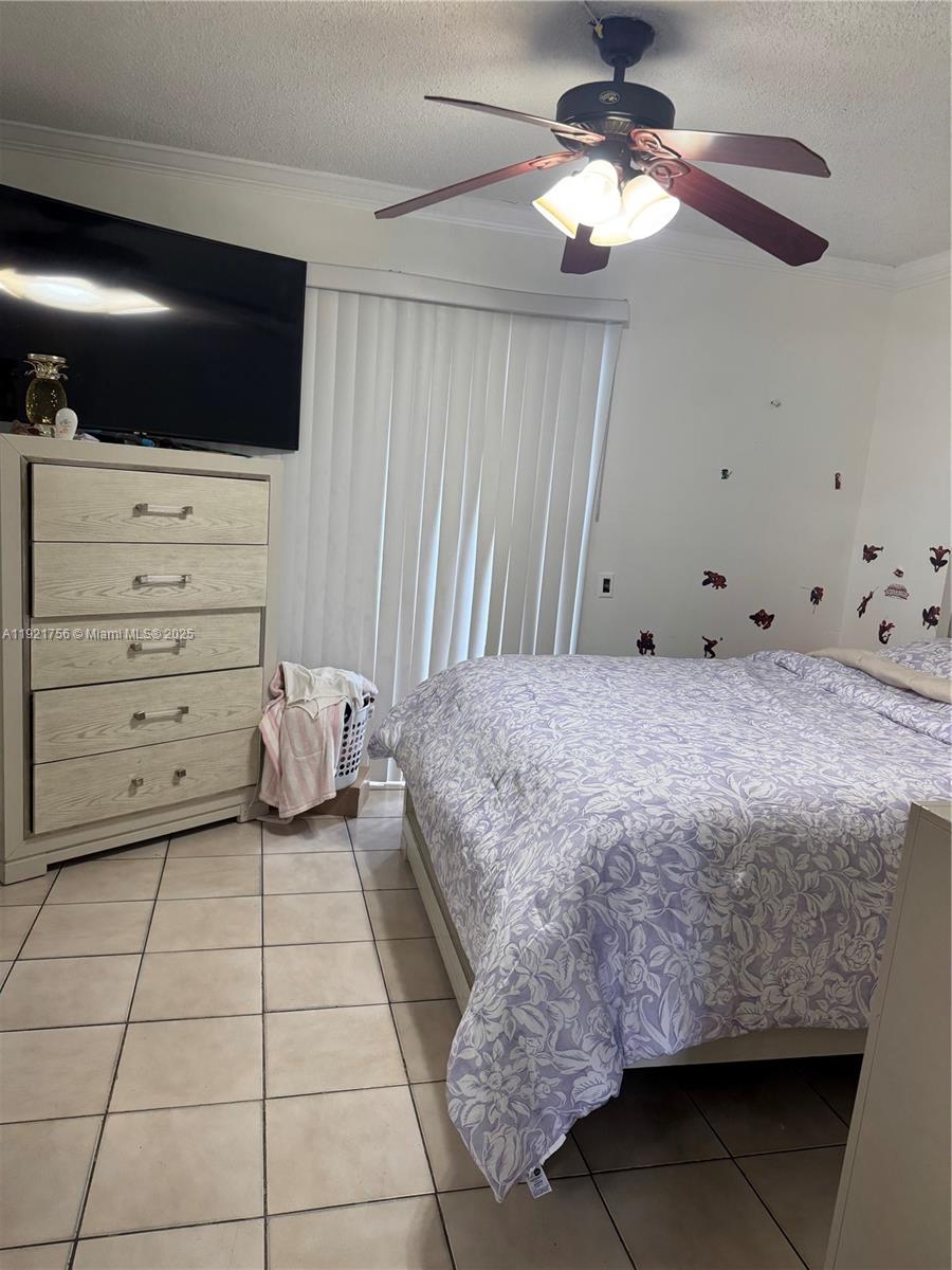 2158 West 60th Street, Unit 13108 Hialeah, FL 33016 - Photo 3 of 3 a bedroom with a bed and a flat screen tv