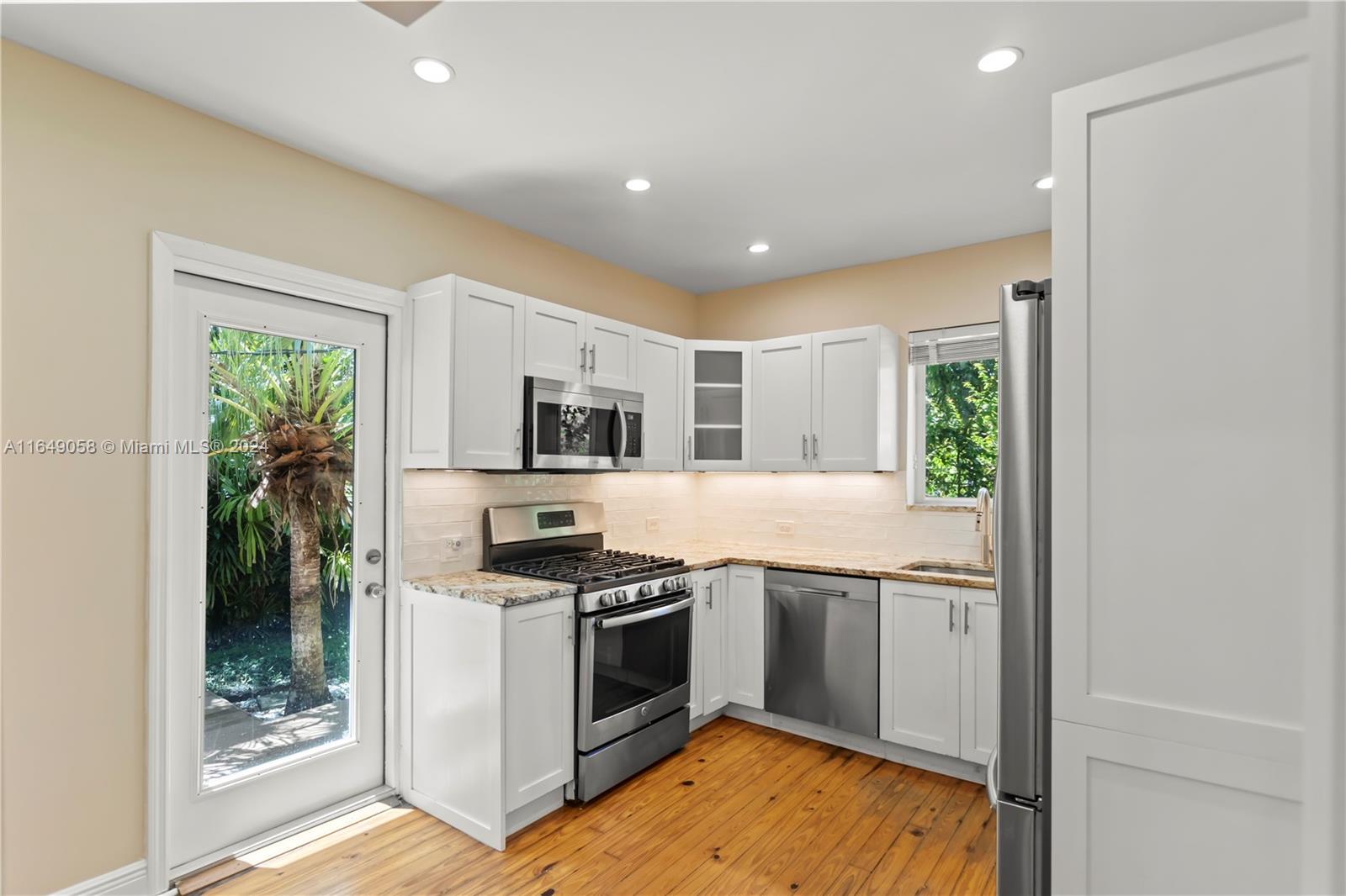 610 Southwest 25th Road Miami, FL 33129 - Photo 12 of 46 a kitchen with stainless steel appliances a stove a sink and a refrigerator