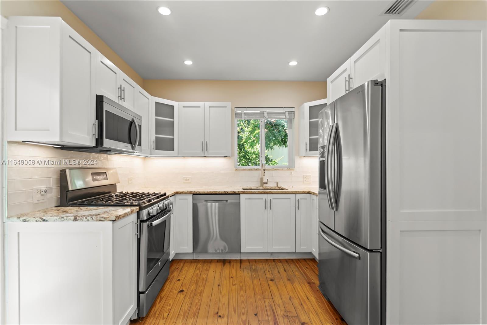 610 Southwest 25th Road Miami, FL 33129 - Photo 14 of 46 a kitchen with stainless steel appliances granite countertop a refrigerator stove and microwave