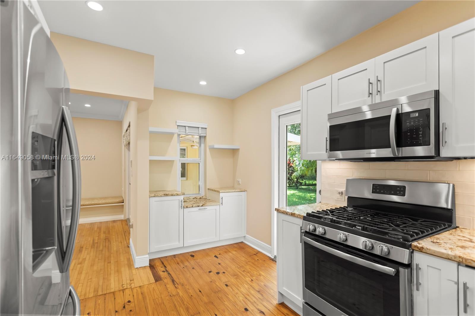 610 Southwest 25th Road Miami, FL 33129 - Photo 15 of 46 a kitchen with stainless steel appliances a stove a microwave and a refrigerator