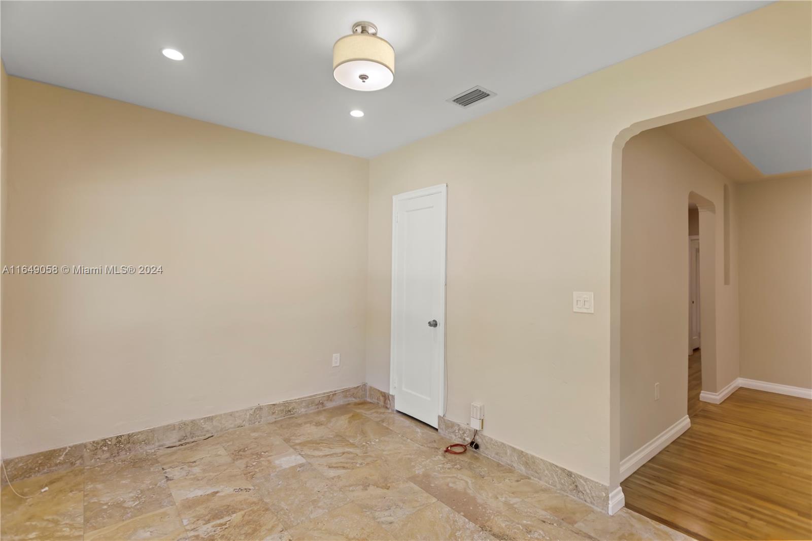 610 Southwest 25th Road Miami, FL 33129 - Photo 19 of 46 an empty room with wooden floor and entrance