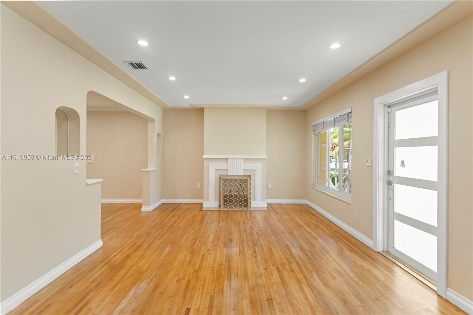 610 Southwest 25th Road Miami, FL 33129 - Photo 2 of 46 a view of empty room with wooden floor and fan