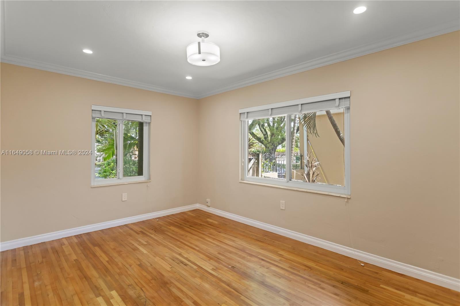 610 Southwest 25th Road Miami, FL 33129 - Photo 22 of 46 a view of an empty room with wooden floor and a window
