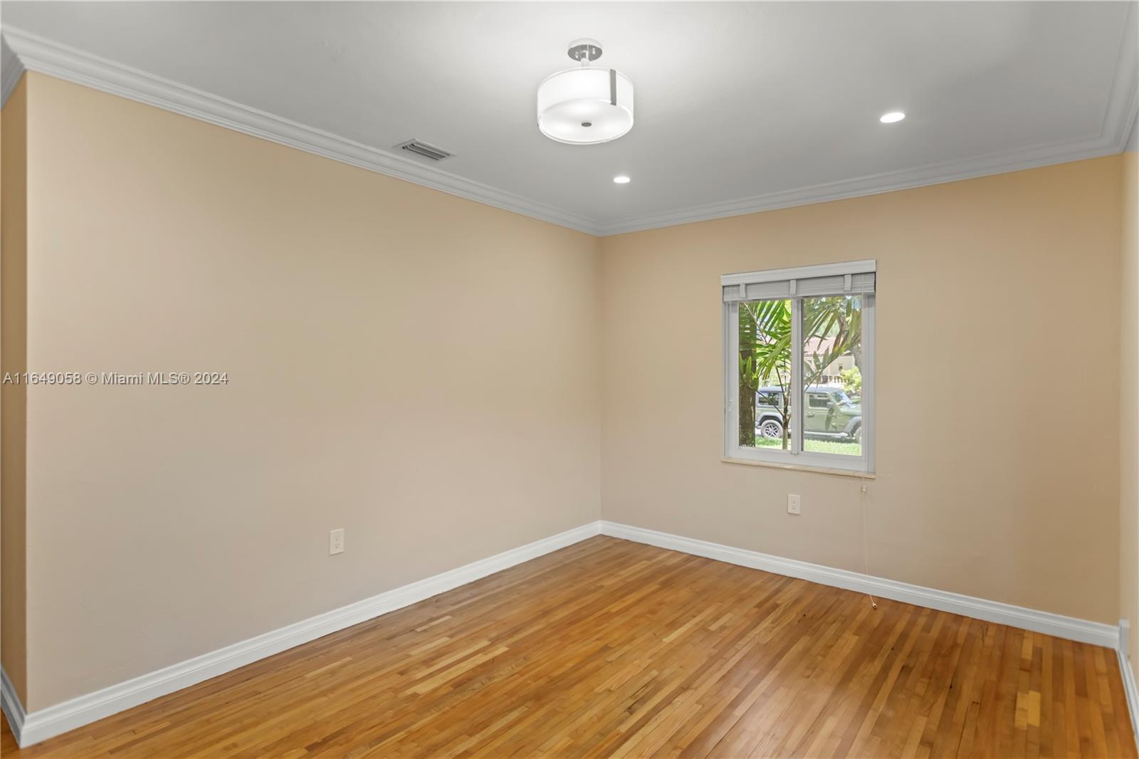610 Southwest 25th Road Miami, FL 33129 - Photo 23 of 46 an empty room with wooden floor and windows