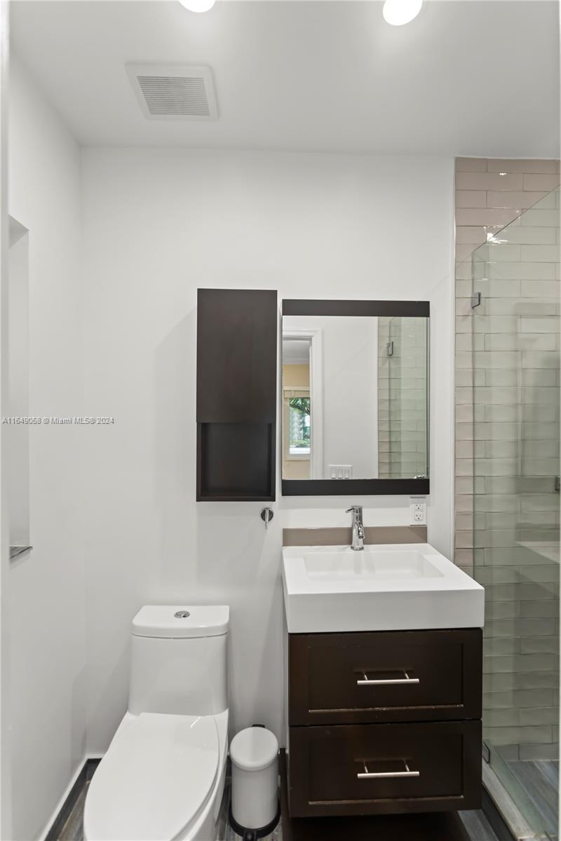610 Southwest 25th Road Miami, FL 33129 - Photo 24 of 46 a bathroom with a sink toilet a mirror and shower