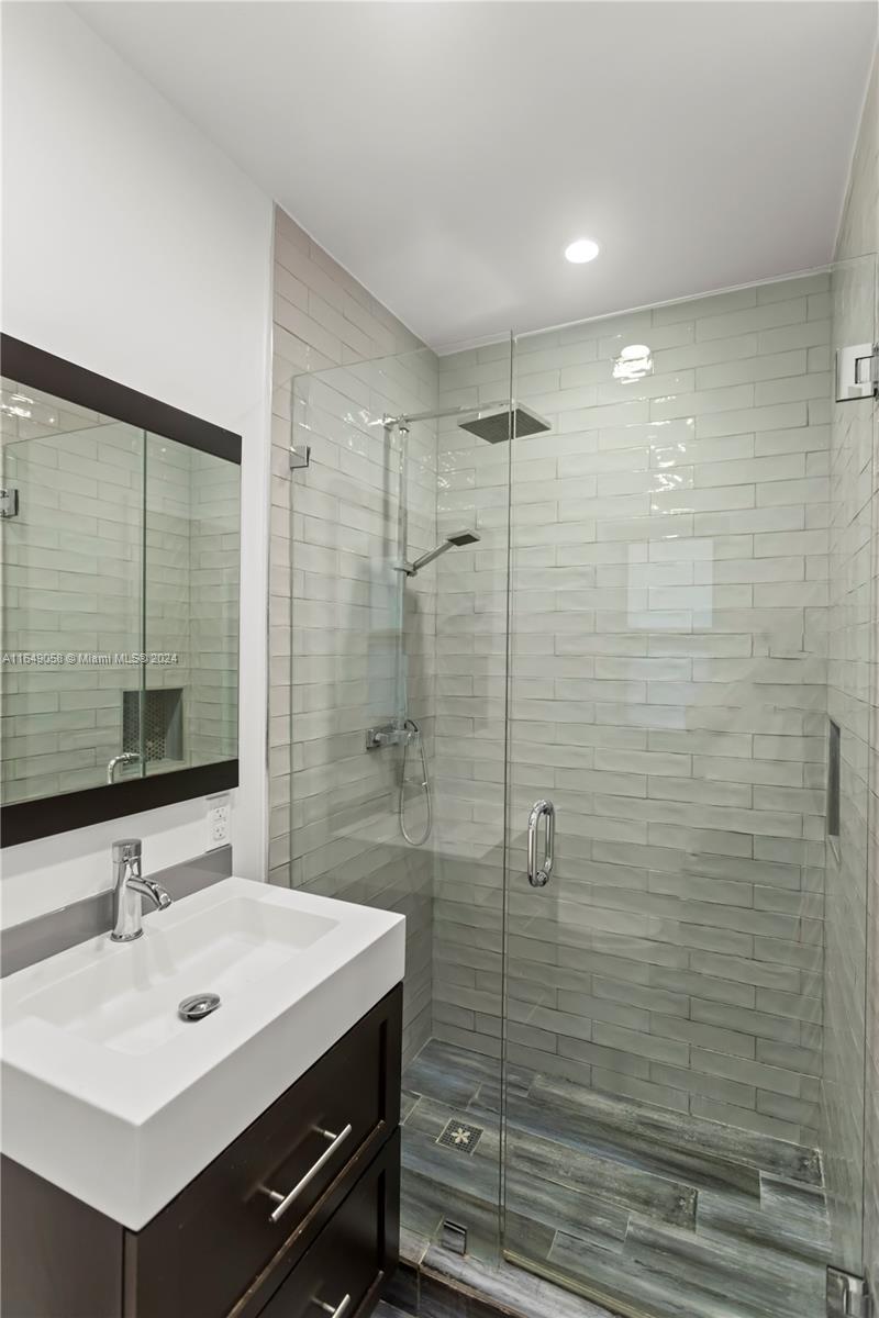 610 Southwest 25th Road Miami, FL 33129 - Photo 25 of 46 a bathroom with a sink mirror and shower