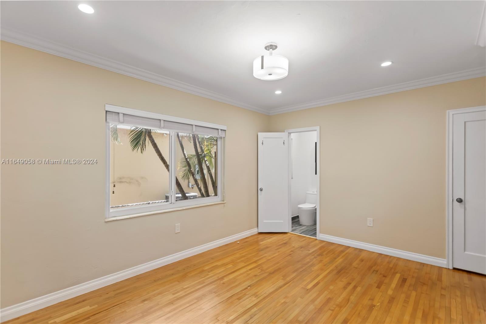 610 Southwest 25th Road Miami, FL 33129 - Photo 26 of 46 a view of empty room with wooden floor and fan