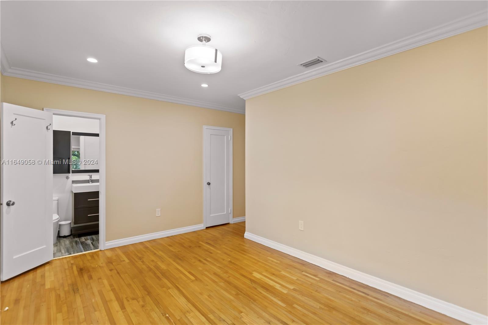 610 Southwest 25th Road Miami, FL 33129 - Photo 27 of 46 a big room with wooden floor and kitchen view