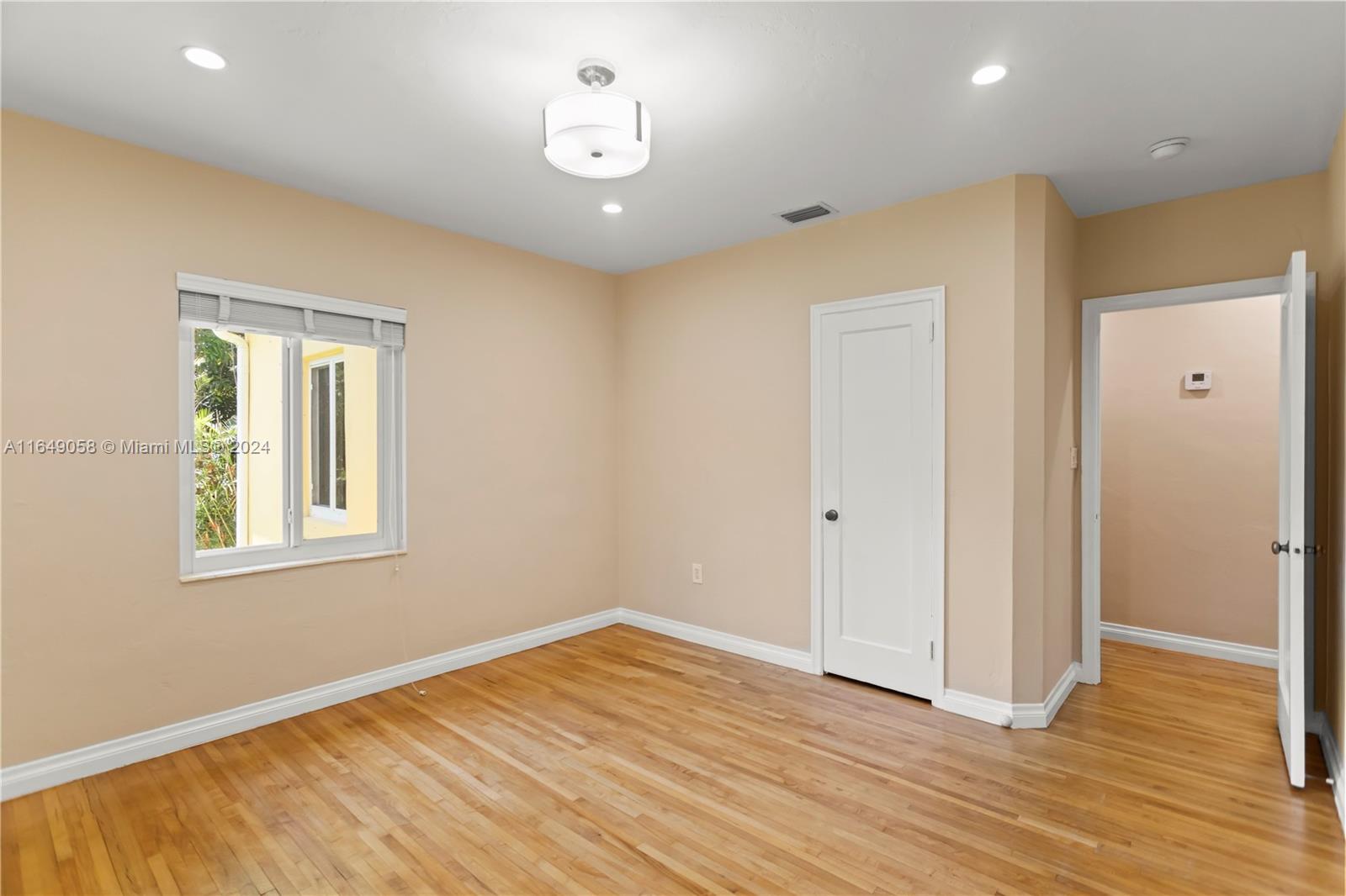 610 Southwest 25th Road Miami, FL 33129 - Photo 29 of 46 a view of empty room with wooden floor and window