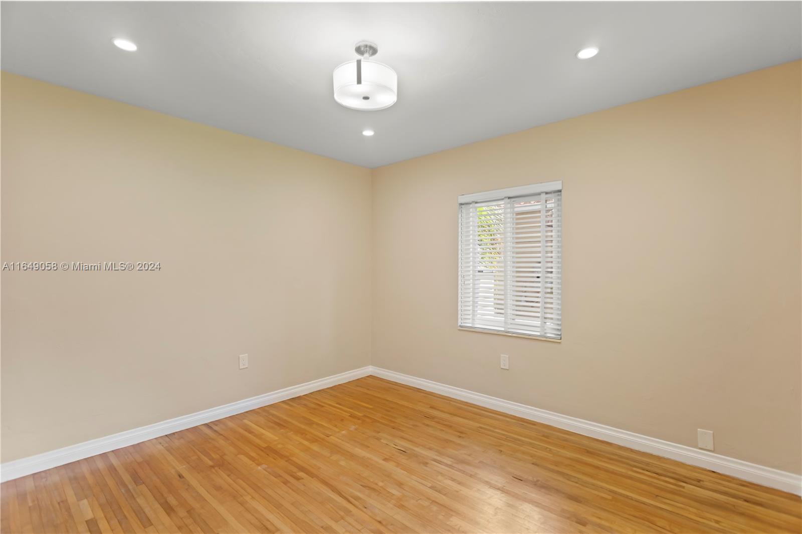 610 Southwest 25th Road Miami, FL 33129 - Photo 31 of 46 en empty room with wooden floor and window