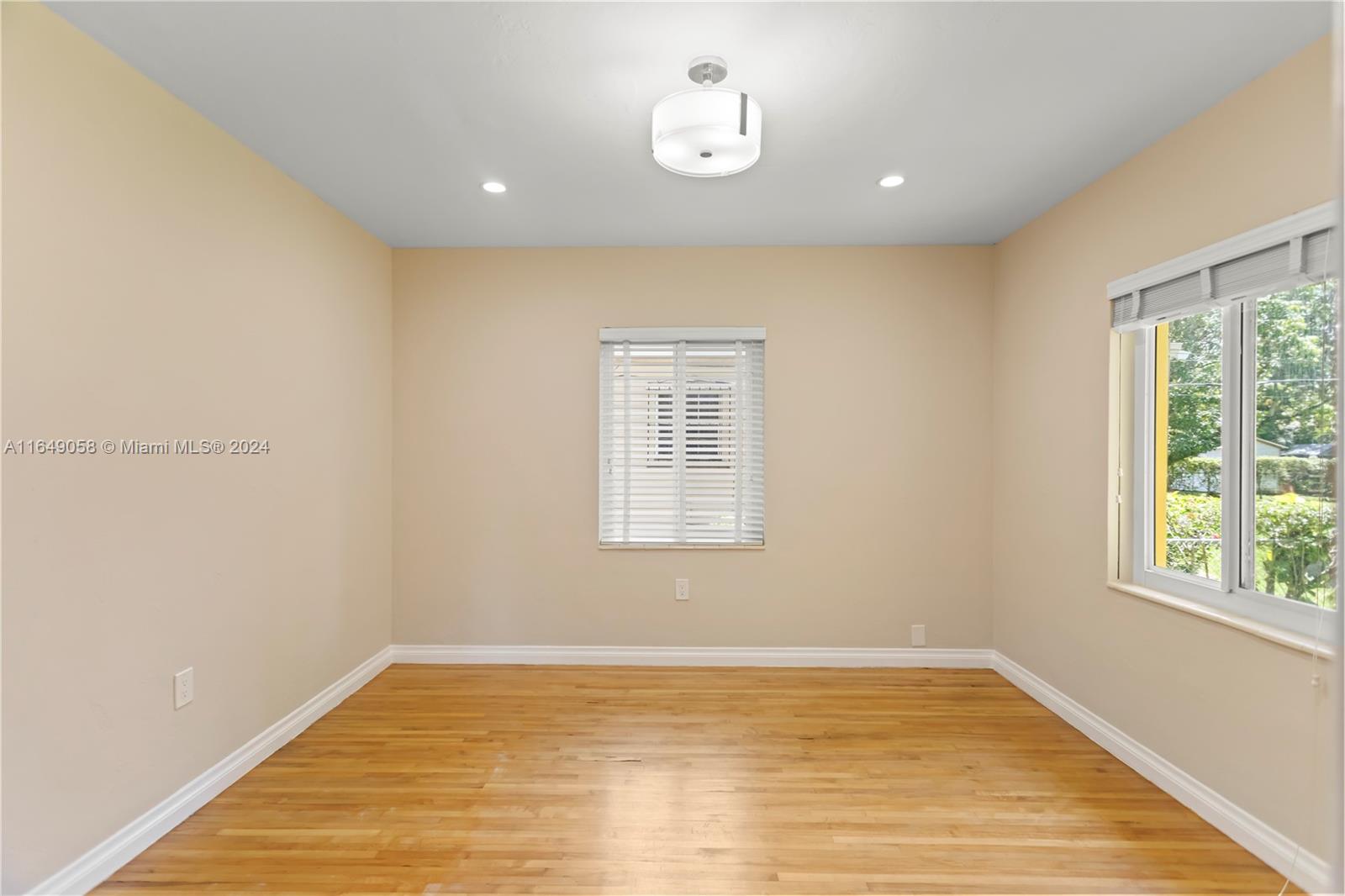 610 Southwest 25th Road Miami, FL 33129 - Photo 32 of 46 a view of an empty room with wooden floor and a window