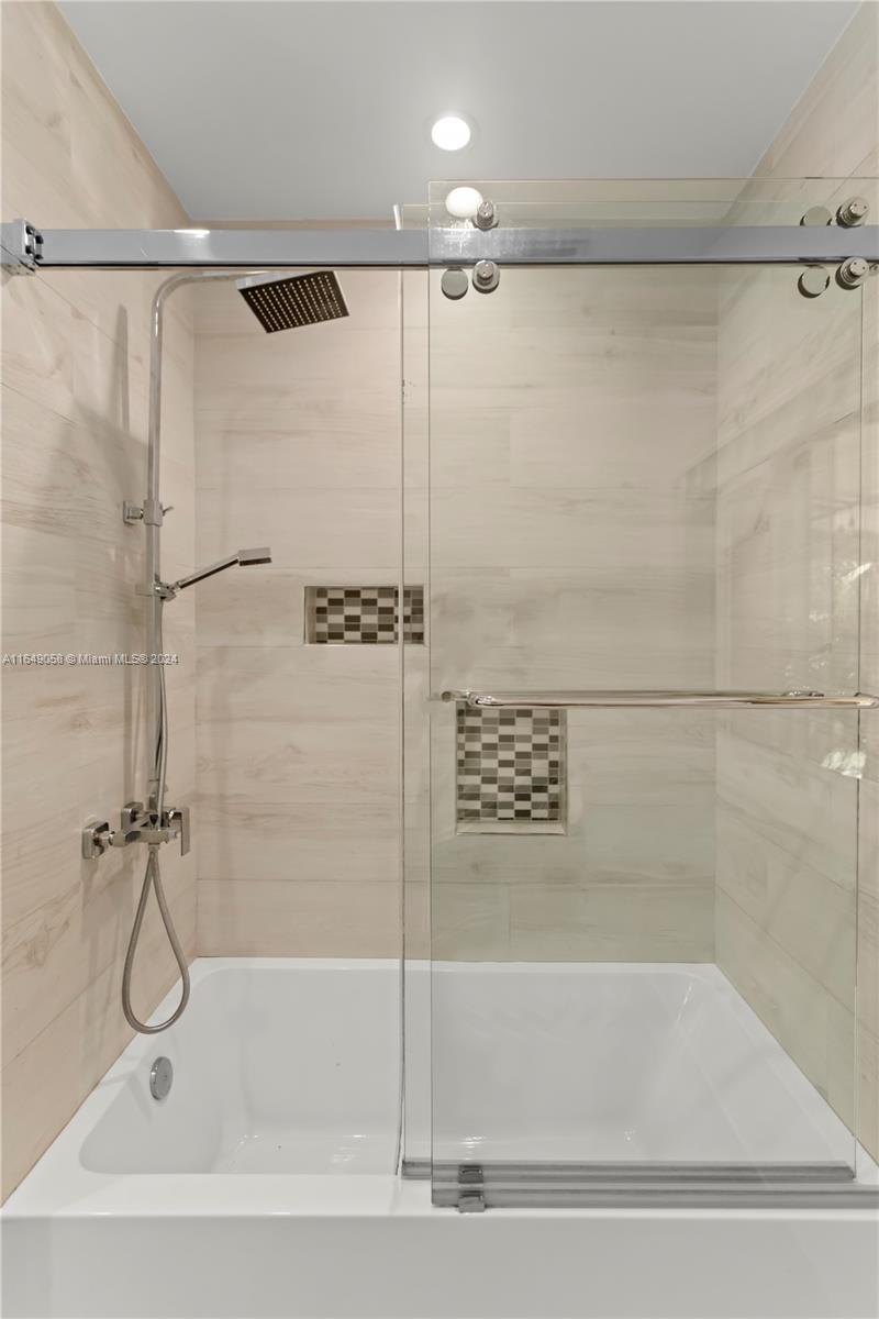 610 Southwest 25th Road Miami, FL 33129 - Photo 34 of 46 a bathroom with a shower and a bathtub