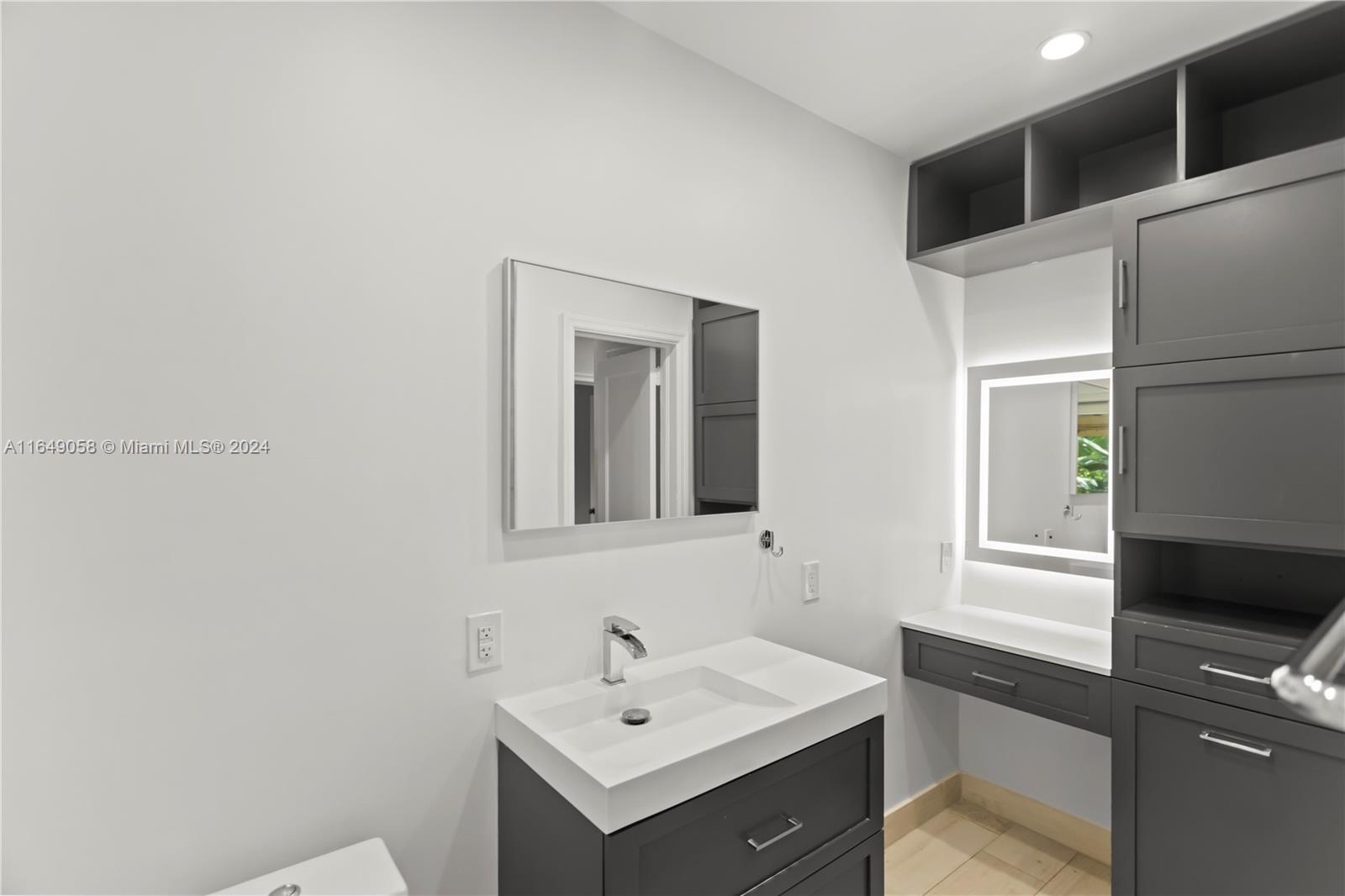 610 Southwest 25th Road Miami, FL 33129 - Photo 35 of 46 a bathroom with a sink and a mirror