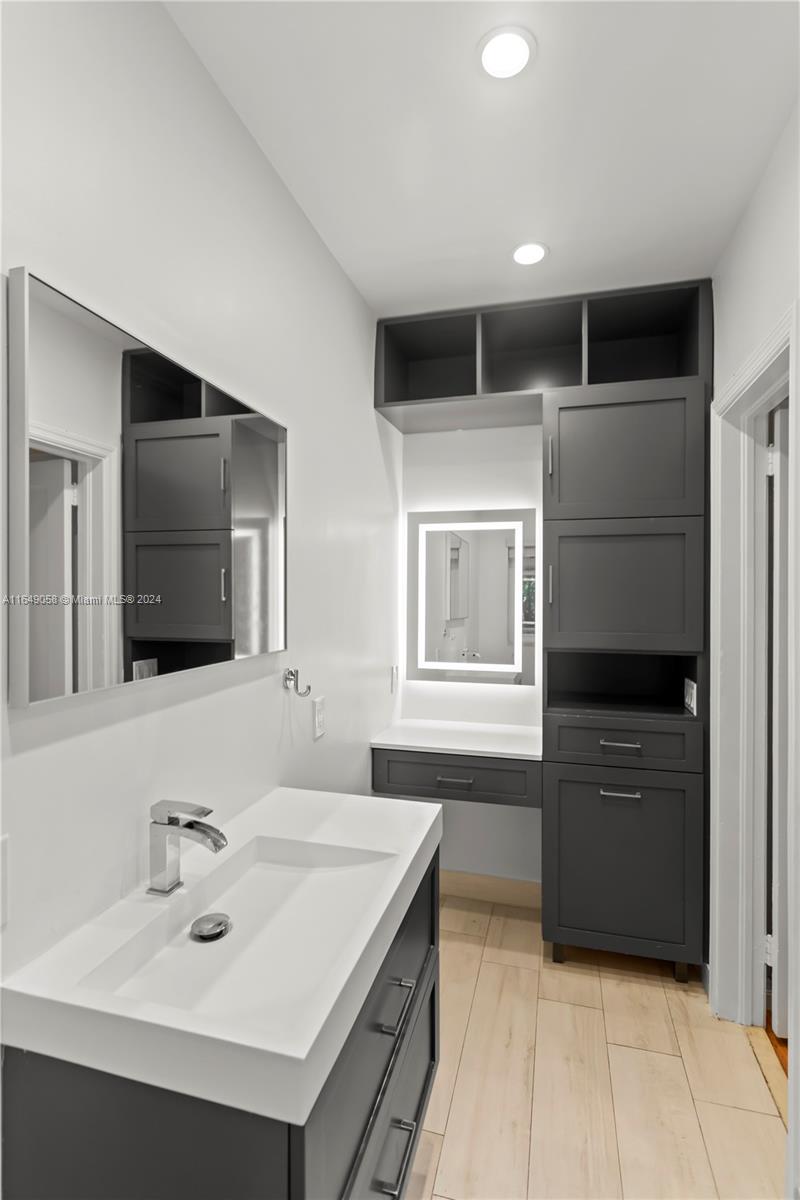 610 Southwest 25th Road Miami, FL 33129 - Photo 36 of 46 a bathroom with a sink and a mirror