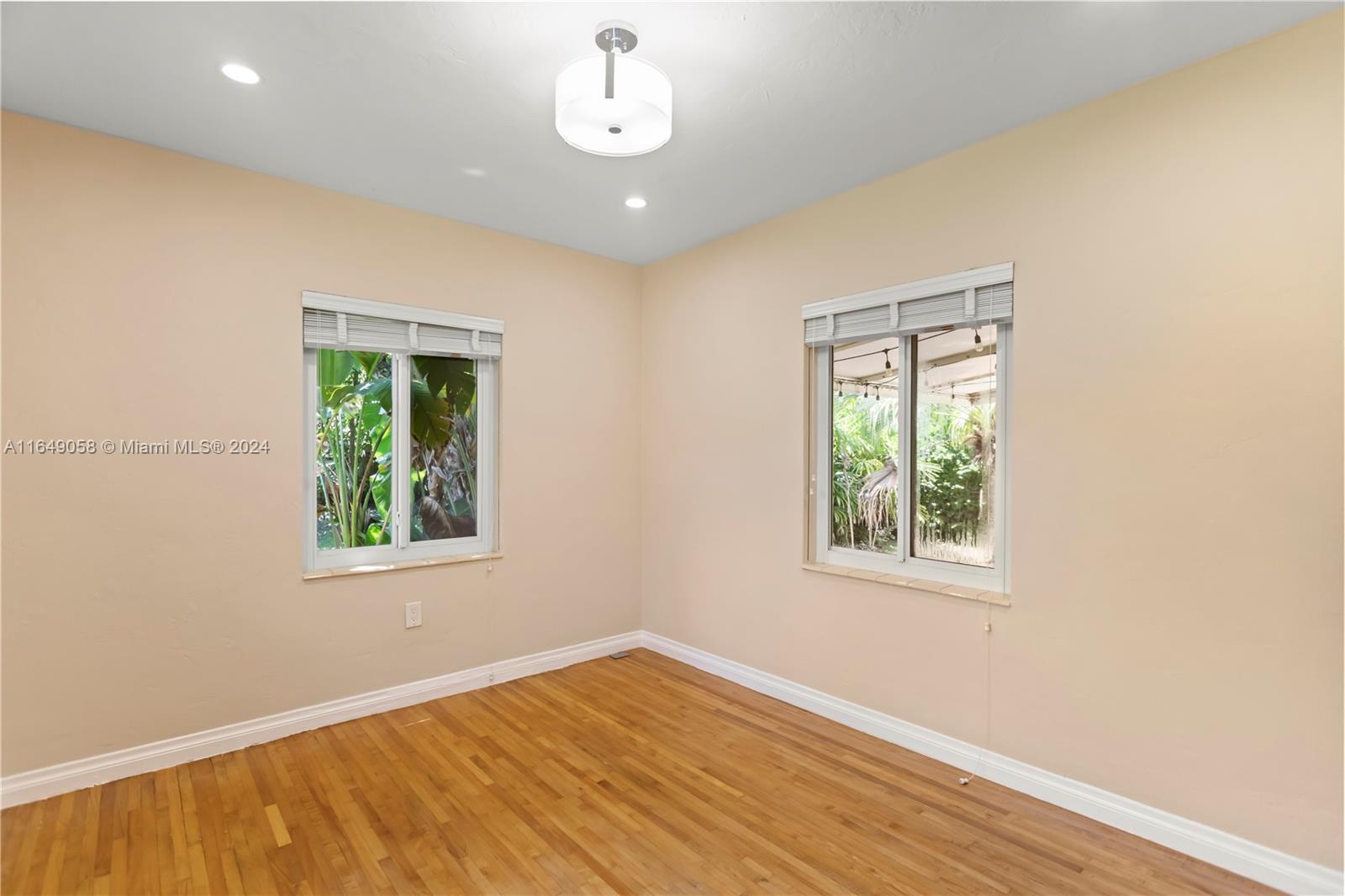 610 Southwest 25th Road Miami, FL 33129 - Photo 38 of 46 an empty room with wooden floor and windows