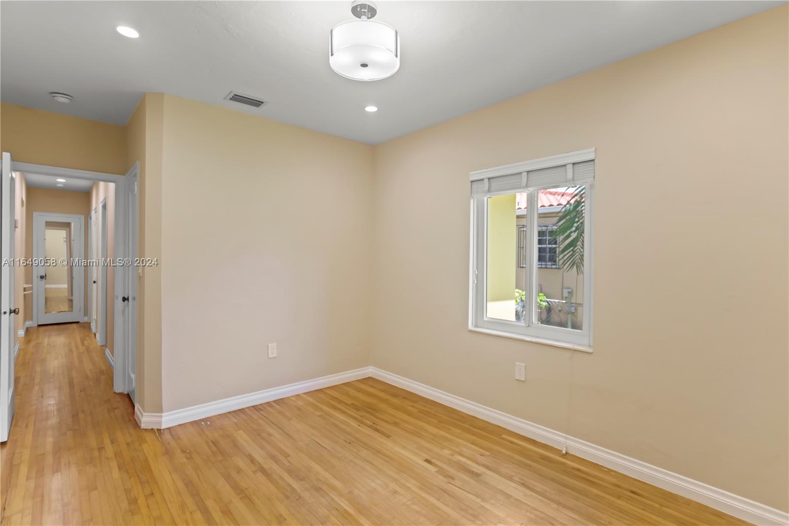 610 Southwest 25th Road Miami, FL 33129 - Photo 40 of 46 an empty room with wooden floor and windows