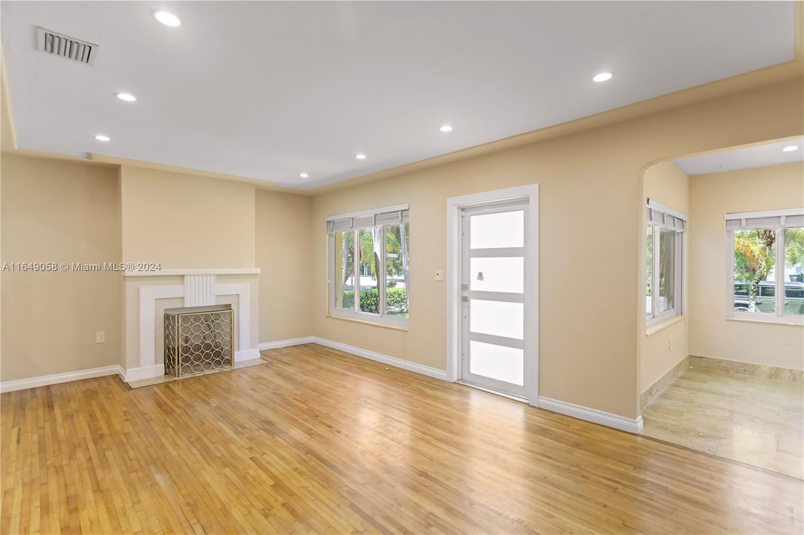 610 Southwest 25th Road Miami, FL 33129 - Photo 4 of 46 an empty room with windows and fireplace