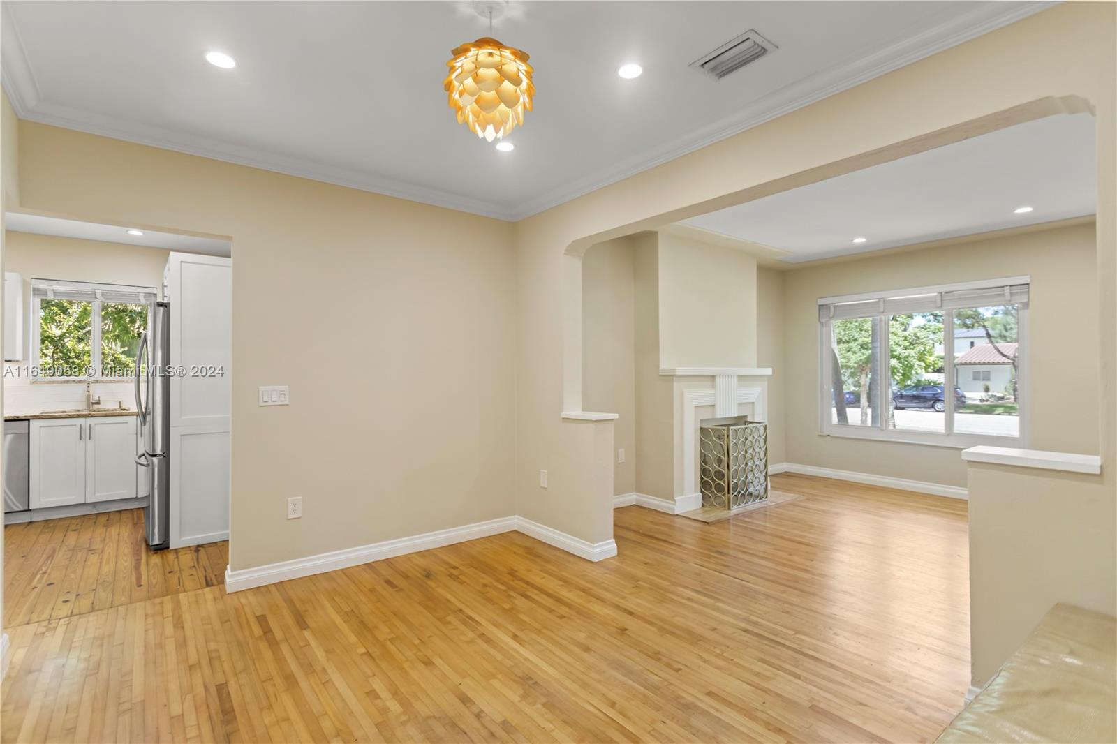 610 Southwest 25th Road Miami, FL 33129 - Photo 7 of 46 an empty room with wooden floor and windows