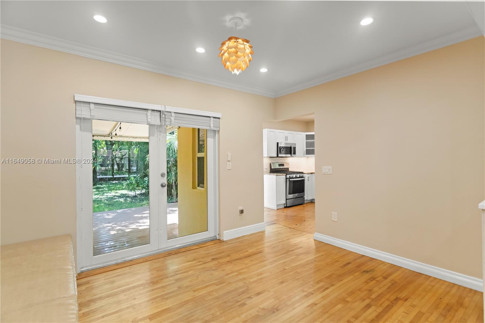 610 Southwest 25th Road Miami, FL 33129 - Photo 8 of 46 a view of an empty room with wooden floor and a window