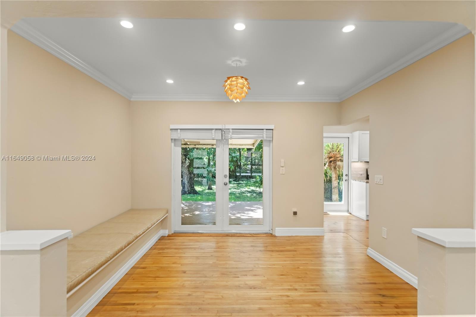 610 Southwest 25th Road Miami, FL 33129 - Photo 9 of 46 a view of an empty room with wooden floor and a window